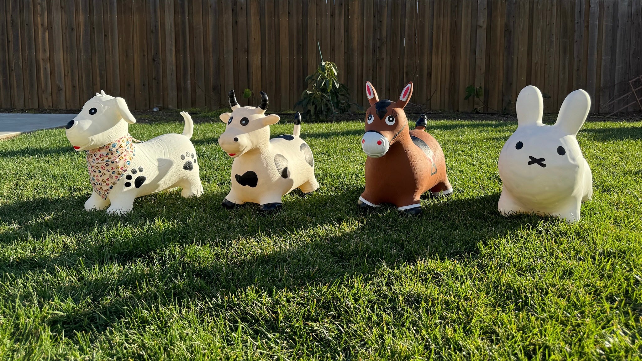 Photo of four toddler hoppers. White dog with black spots shaped as paw prints. White cow with black spots. Brown horse. White bunny. 